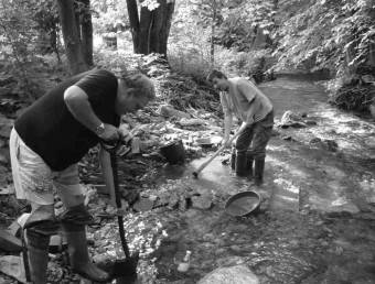 Men mining for gold near water