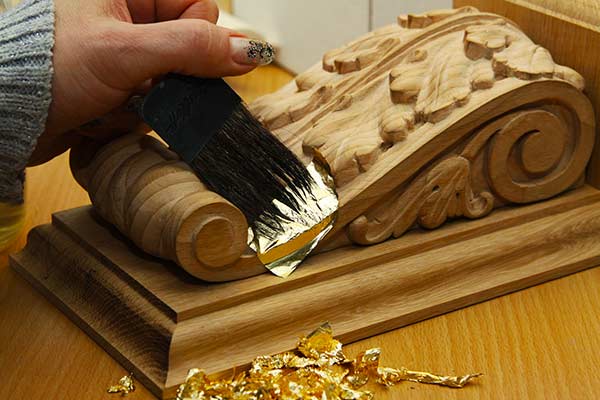 Applying gold leaf sheets