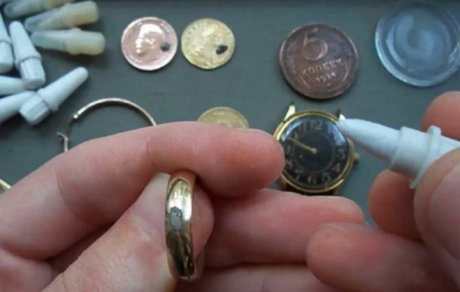 checking a gold ring with a lapis pencil