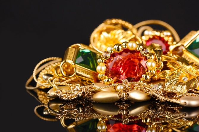 gold and jewelry with red and green stones